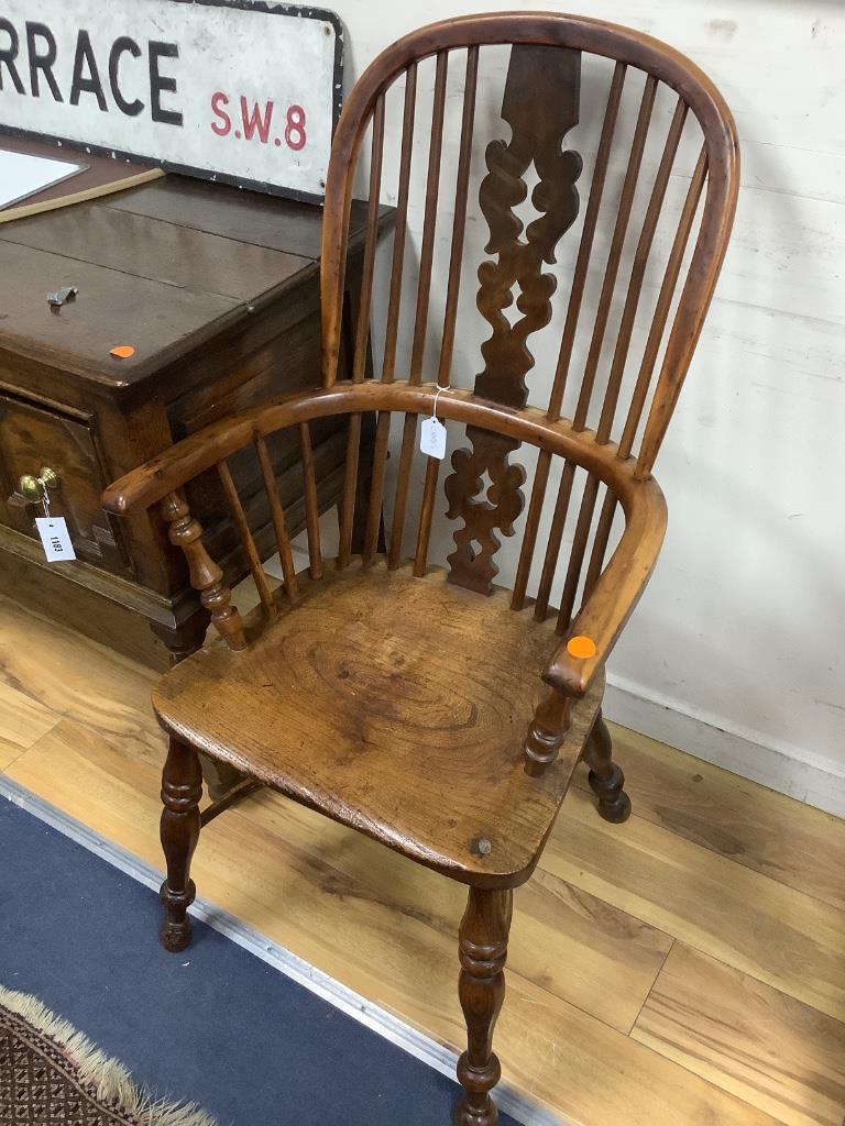 A single early 19th century yew and elm elbow chair